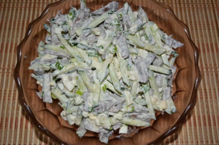 Салат из свиного сердца, плавленого сыра, огурцов и зелени